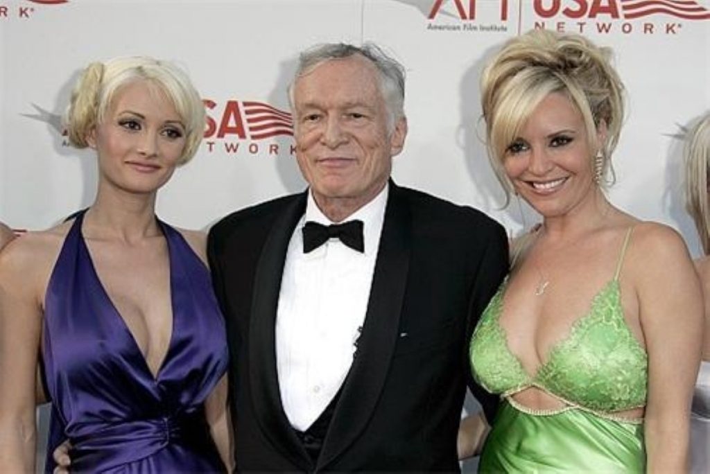 Hugh Hefner with two models. The Playboy founder is widely considered to have brought the industry some mainstream acceptibility.