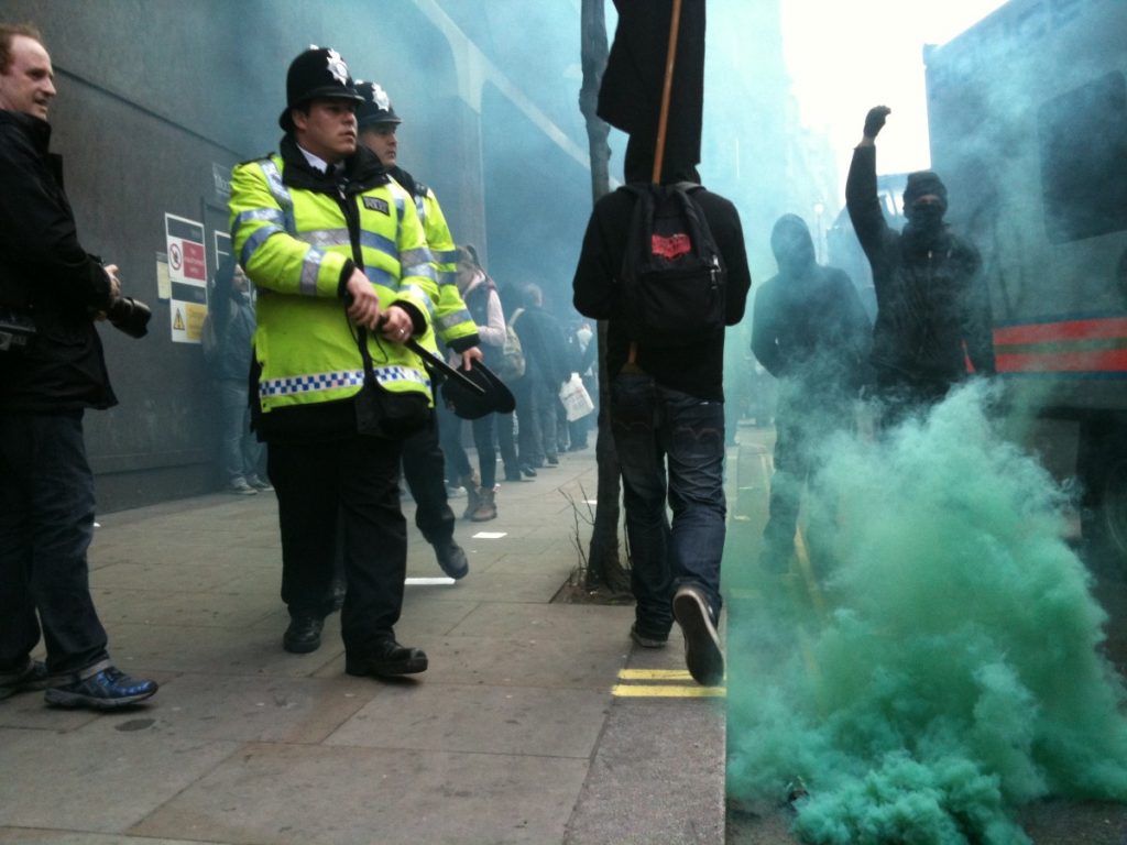 Police deal with anarchist protestors in Soho during the anti-cuts rally