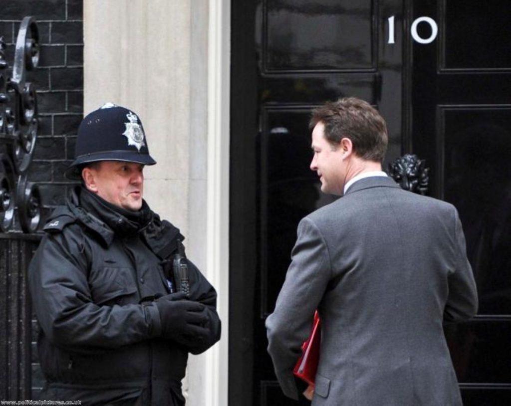 Clegg chit-chats with a policeman on duty outside No 10. Photo: Political Pictures