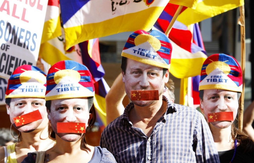 Protestors symbolise David Cameron's silence over human rights during a protest yesterday.