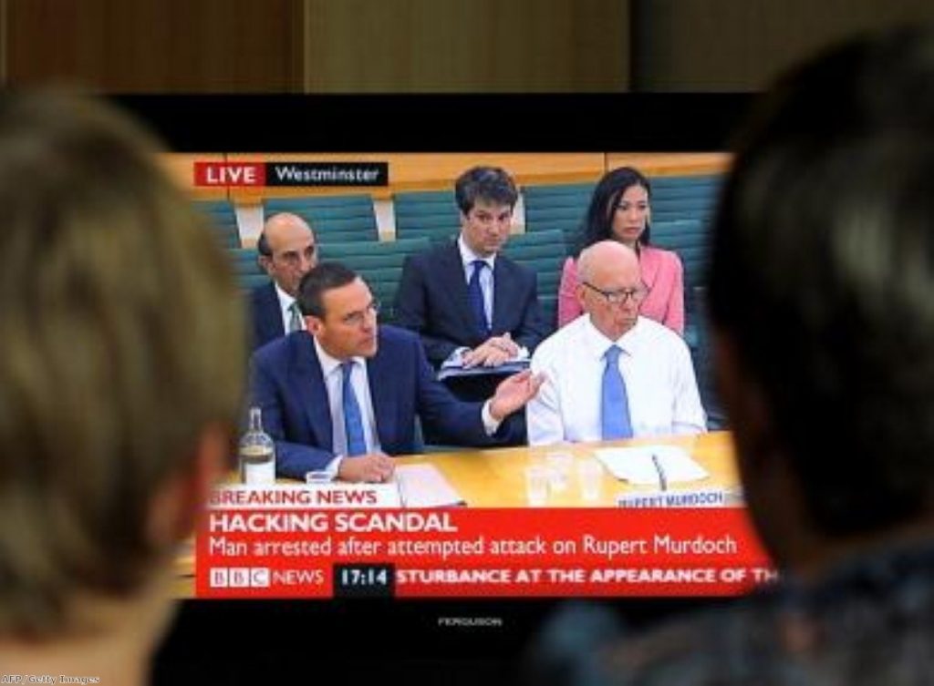 James Murdoch and his father Rupert appear before MPs last summer