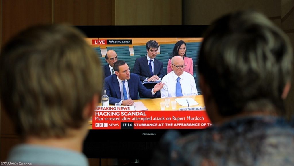 Centre of the storm: James and Rupert Murdoch at the select committee. Photo: AFP/Getty Images