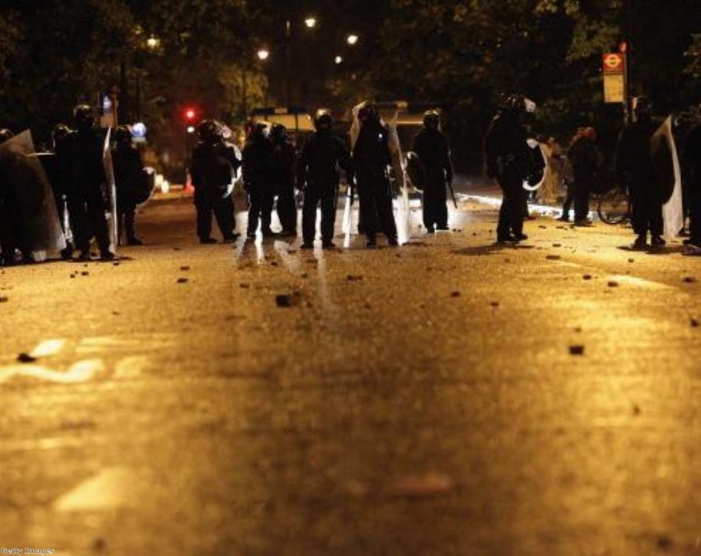 Police are confronted by several hundred youths in Brixton last night