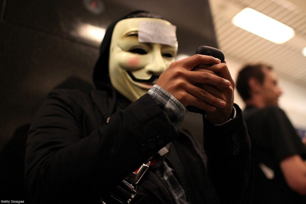 A demonstrator tries to use his phone during a protest in San Francisco in 2011. Civil liberties campaigners warn the snoopers' charter plans give too many powers to authorities.