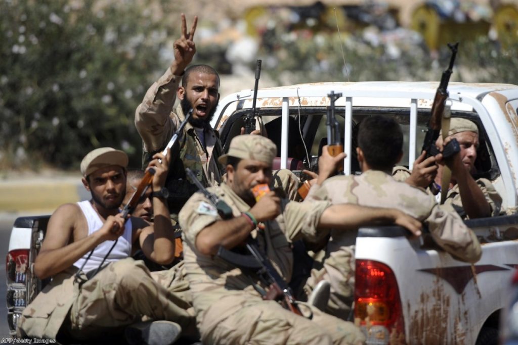 Rebel fighters ride along towards Jdaim, west of Tripoli, earlier this week.