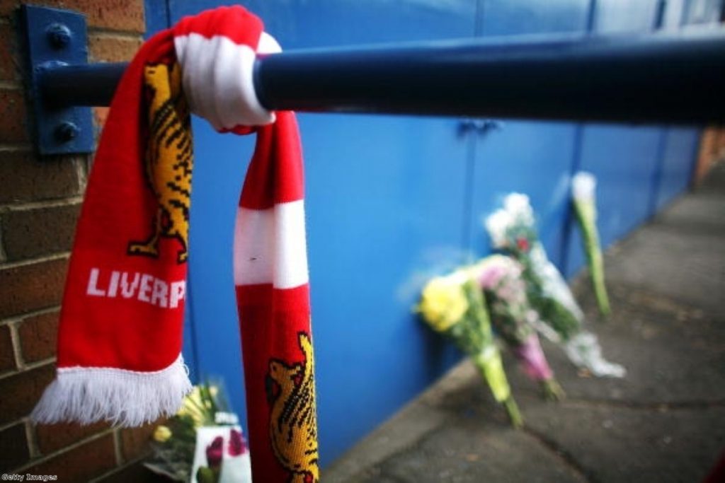 Floral tributes and Liverpool scarves lay in tribute next to the Leppings Lane entrance of Hillsborough Stadium