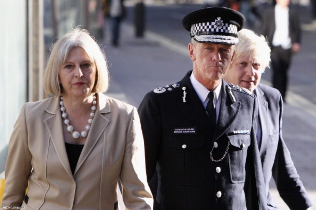 Bernard Hogan-Howe stands next to home secretary Theresa May and London mayor Boris Johnson. He is taking a more hardline stance on drugs than many of his contemporaries.