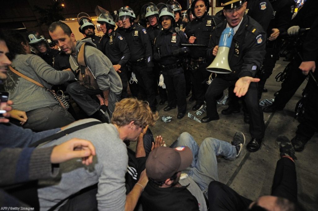 Riot police try to break up a protest in Wall Street this weekend.