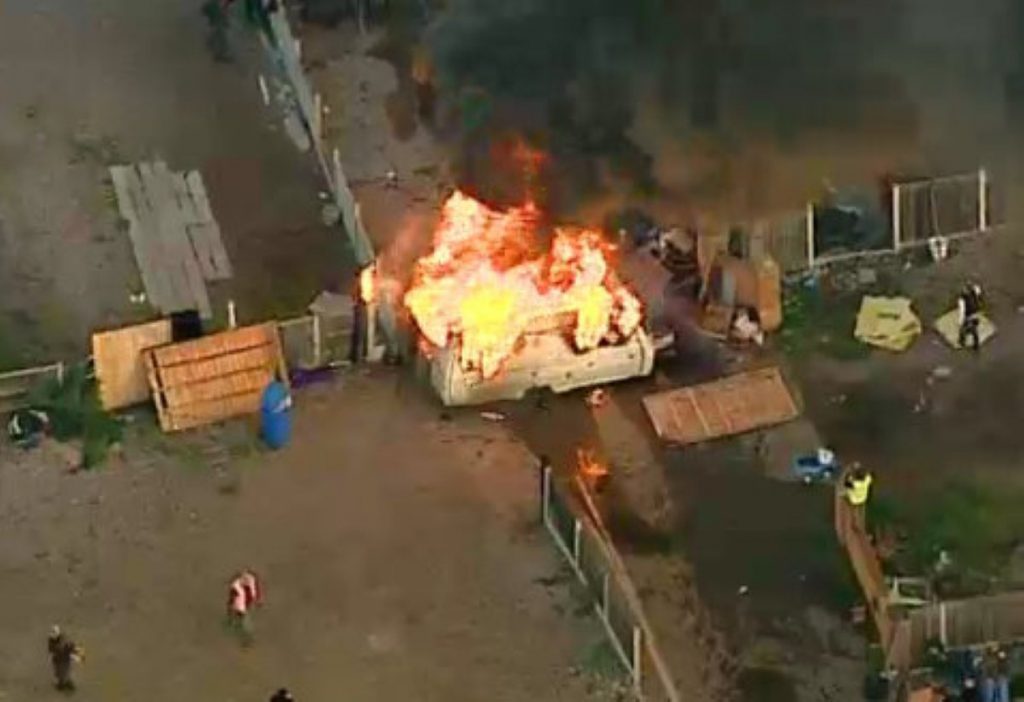 A caravan is set on fire during the eviction at Dale Farm