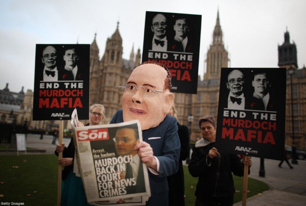 Campaigners await James Murdoch outside parliament today