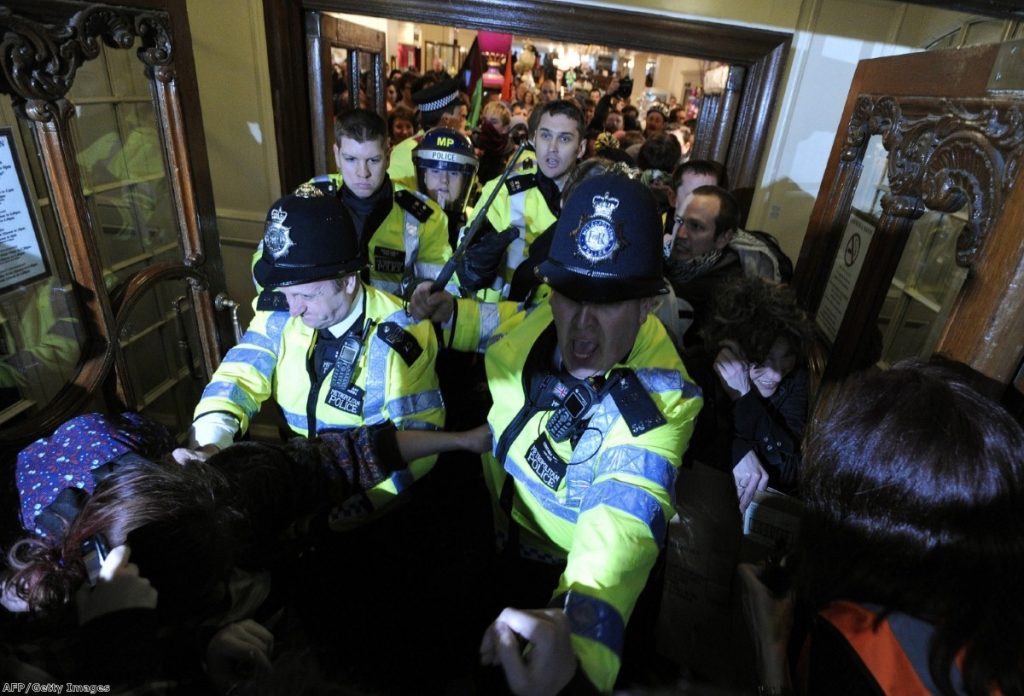 Police challenge UK Uncut demonstrators during a protest in central London last year.