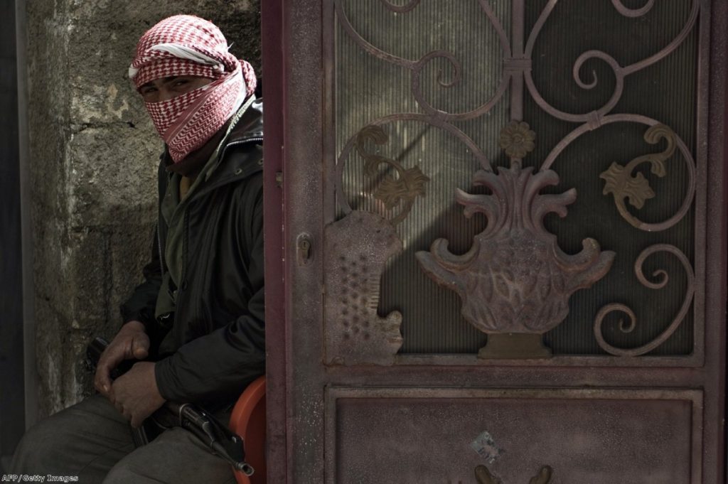 A Free Syria Army rebel waits as the conflict drags on