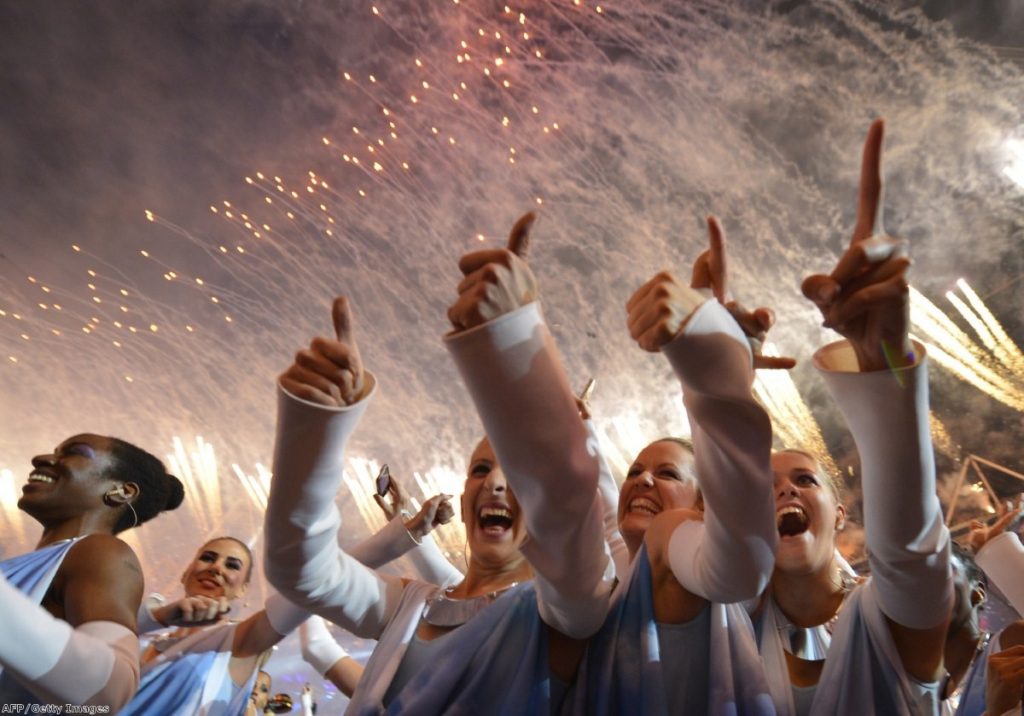 Performers cheer at the closing ceremony last night