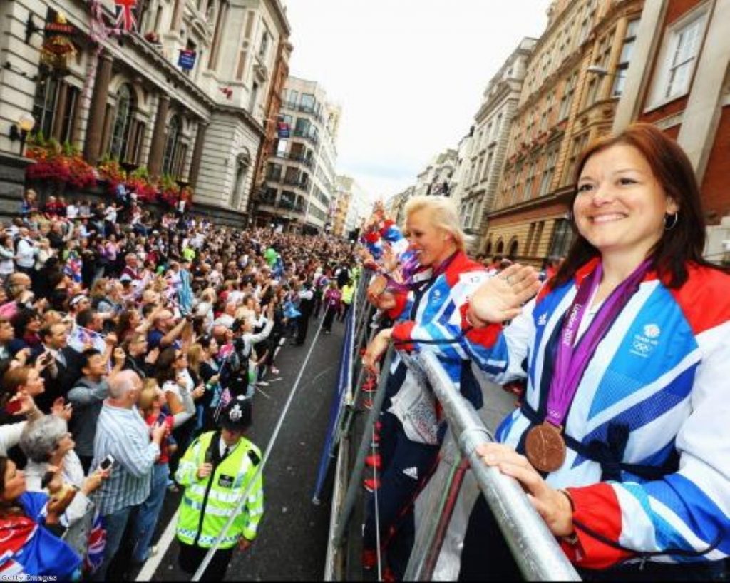 Members of Team GB's women's hockey team greet the crowds during the Olympic parade