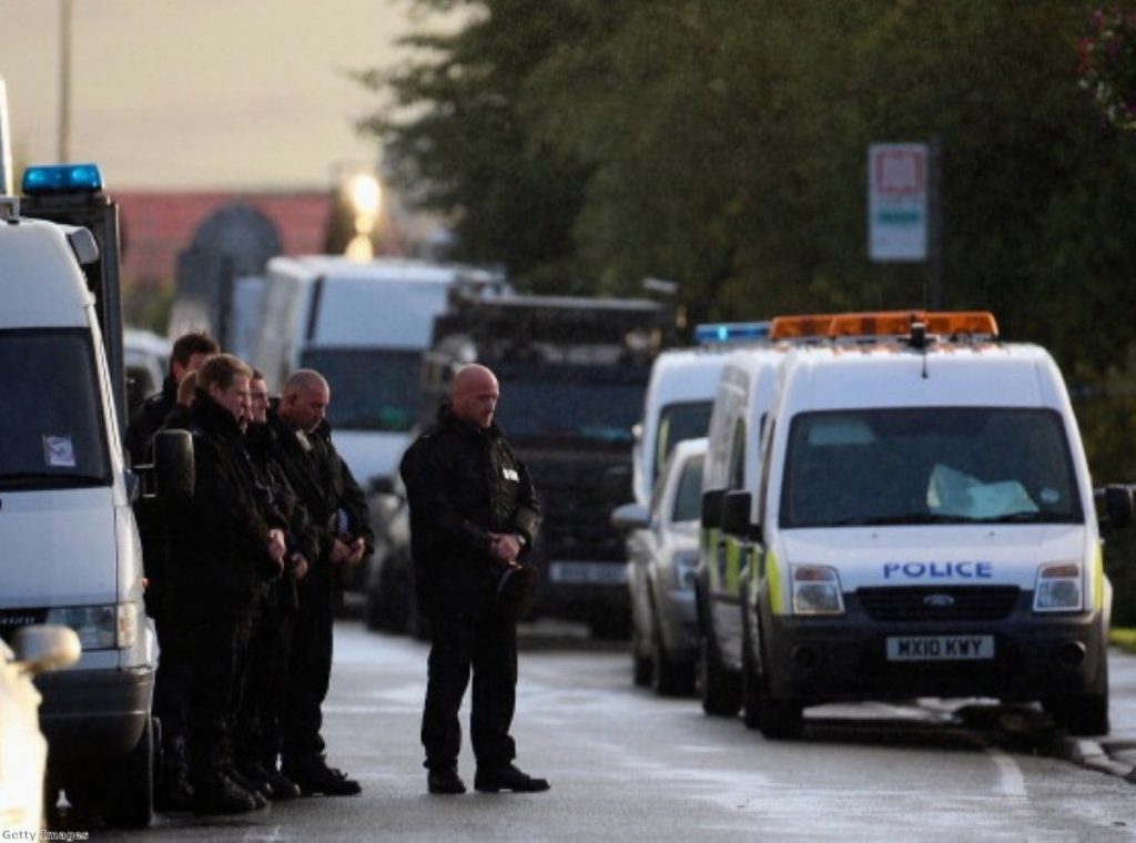 Police pay their respects as the body of a female police officer leaves the scene in Hattersley, Tameside