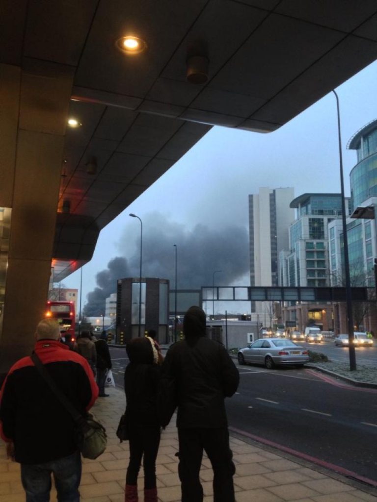 Commuters gaze at the smoke billowing from the crash in central London this morning. Photo credit: Zammurad Salam