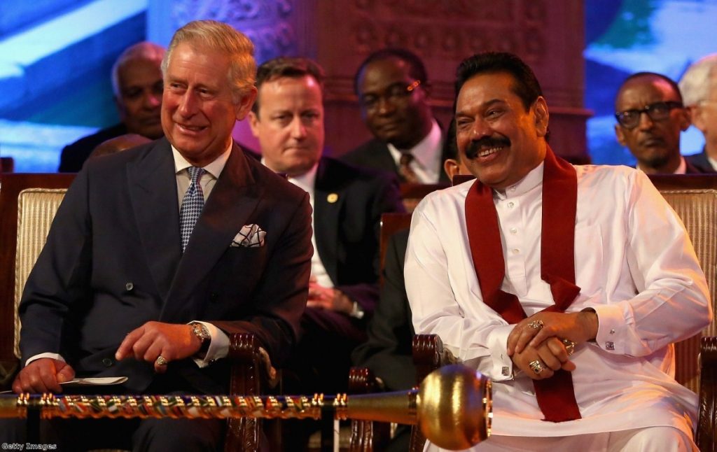 Cameron looks on as Prince Charles and Sri Lankan president Rajapaksa share a joke