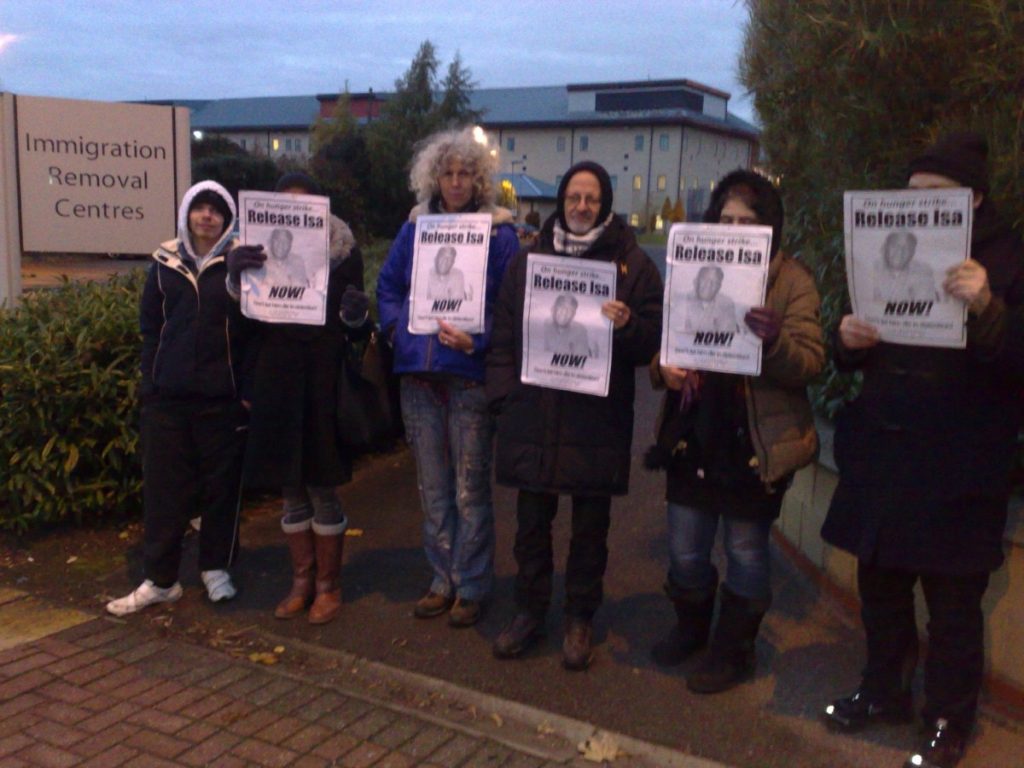 Demonstrators hold a vigil outside Harmondsworth Detention Centre, where Muazu is held