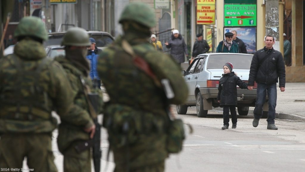 Heavily-armed soldiers maintain watch in a street in Simferopol, Ukraine