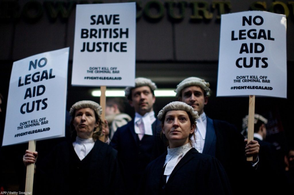 Legal professionals hold placards during a protest against cuts to legal aid outside Southwark Crown Court in January