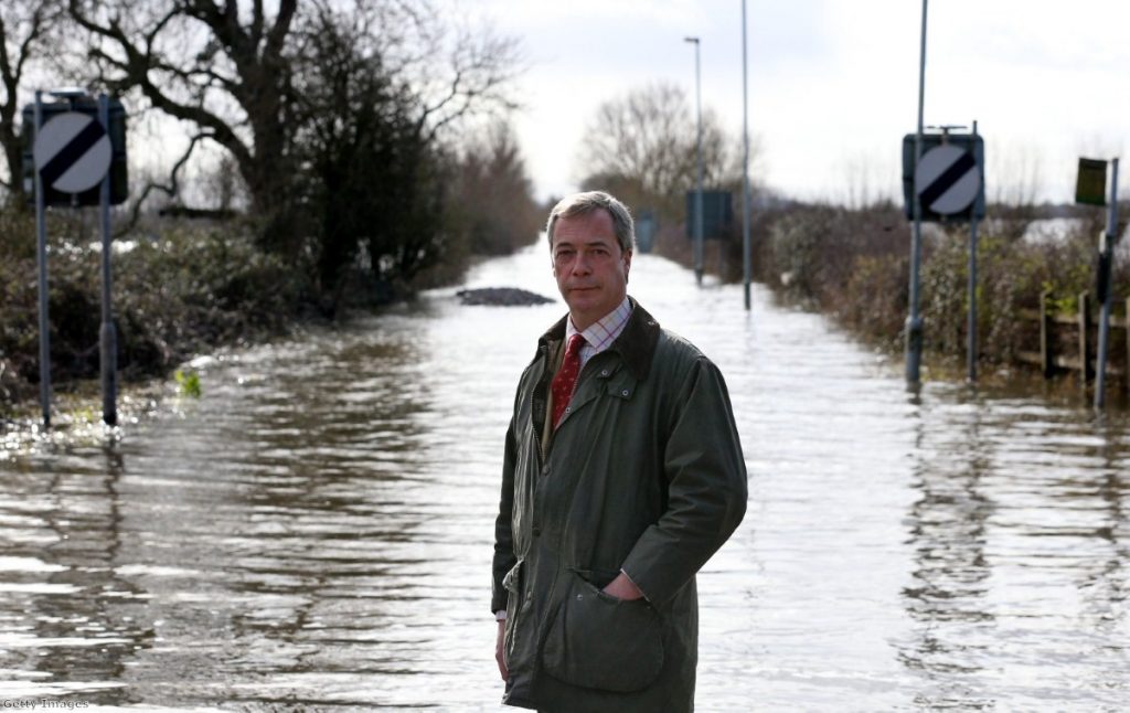 Farage poses for a photograph in front of flood water at Burrowbridge on the Somerset Levels last month