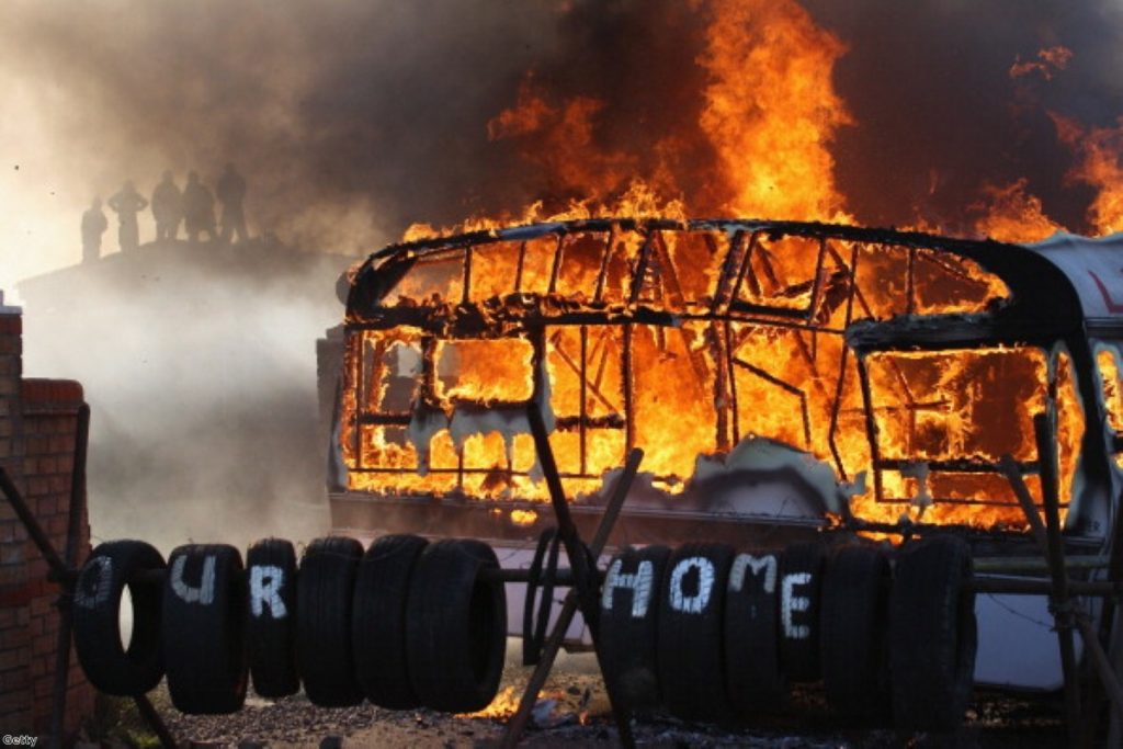 Flames engulf a caravan during the Dale Farm travellers camp eviction in 2011