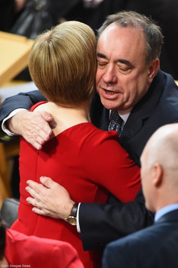 Salmond embraces his successor, Nicola Sturgeon, after he steps down following the failure of the Yes campaign