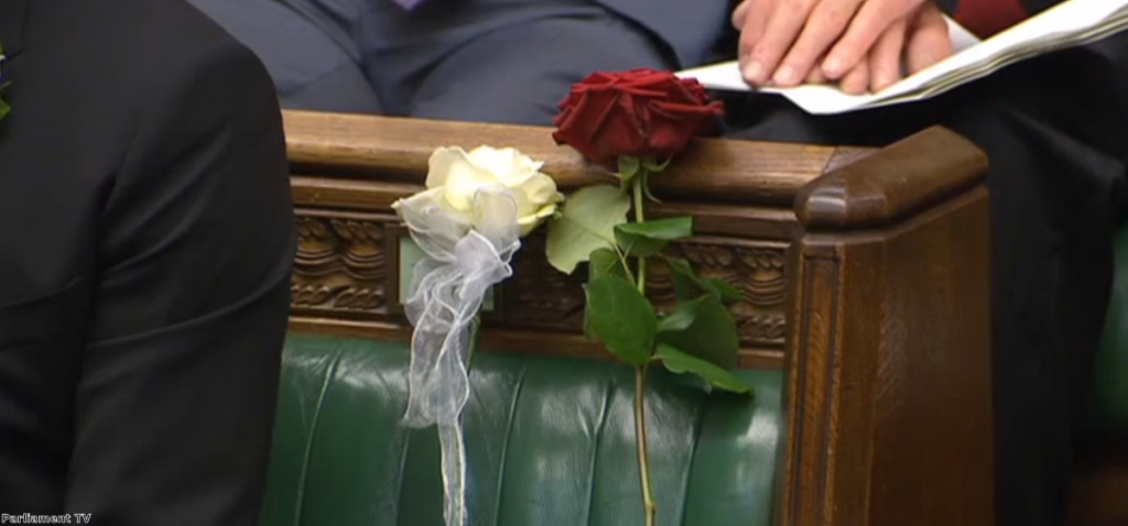 Two roses marked Jo Cox's seat in the Commons during yesterday's tributes