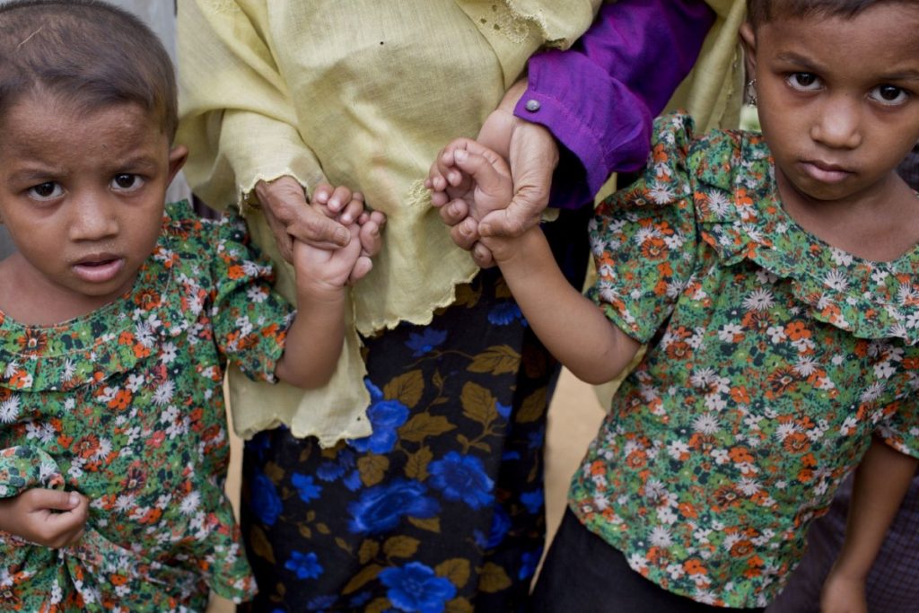 A Rohingya Muslim woman holds the hands of her grandchildren at Balukhali refugee camp in Ukhiya, Bangladesh