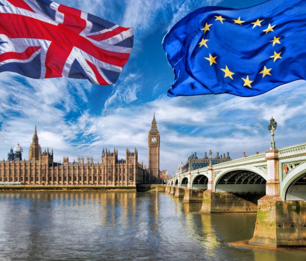 European Union and British Union flags flying against the Houses of Parliament | iStock
