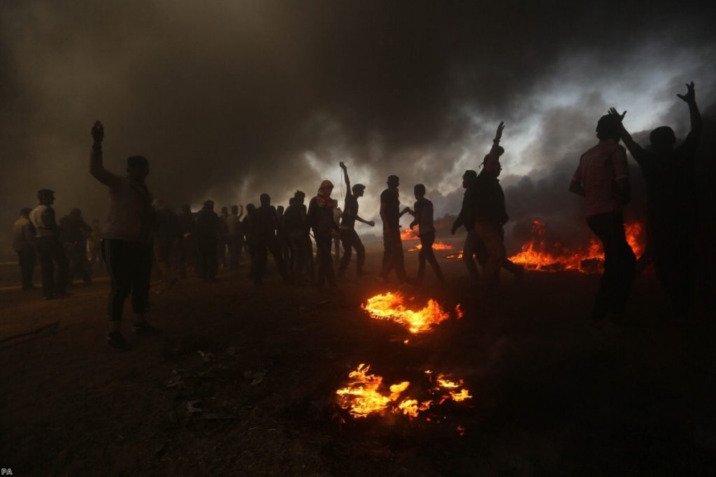 Palestinian protesters clash with Israeli soldiers at the border fence in the southern Gaza Strip | Copyright: PA