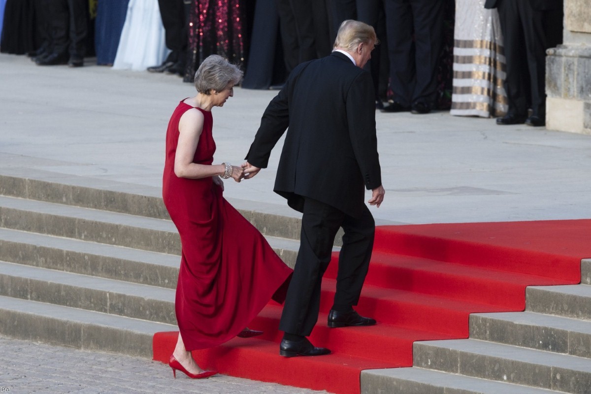 Donald Trump takes the hand of Theresa May as they enter Blenheim Palace on July 12, 2018 | Copyright: PA