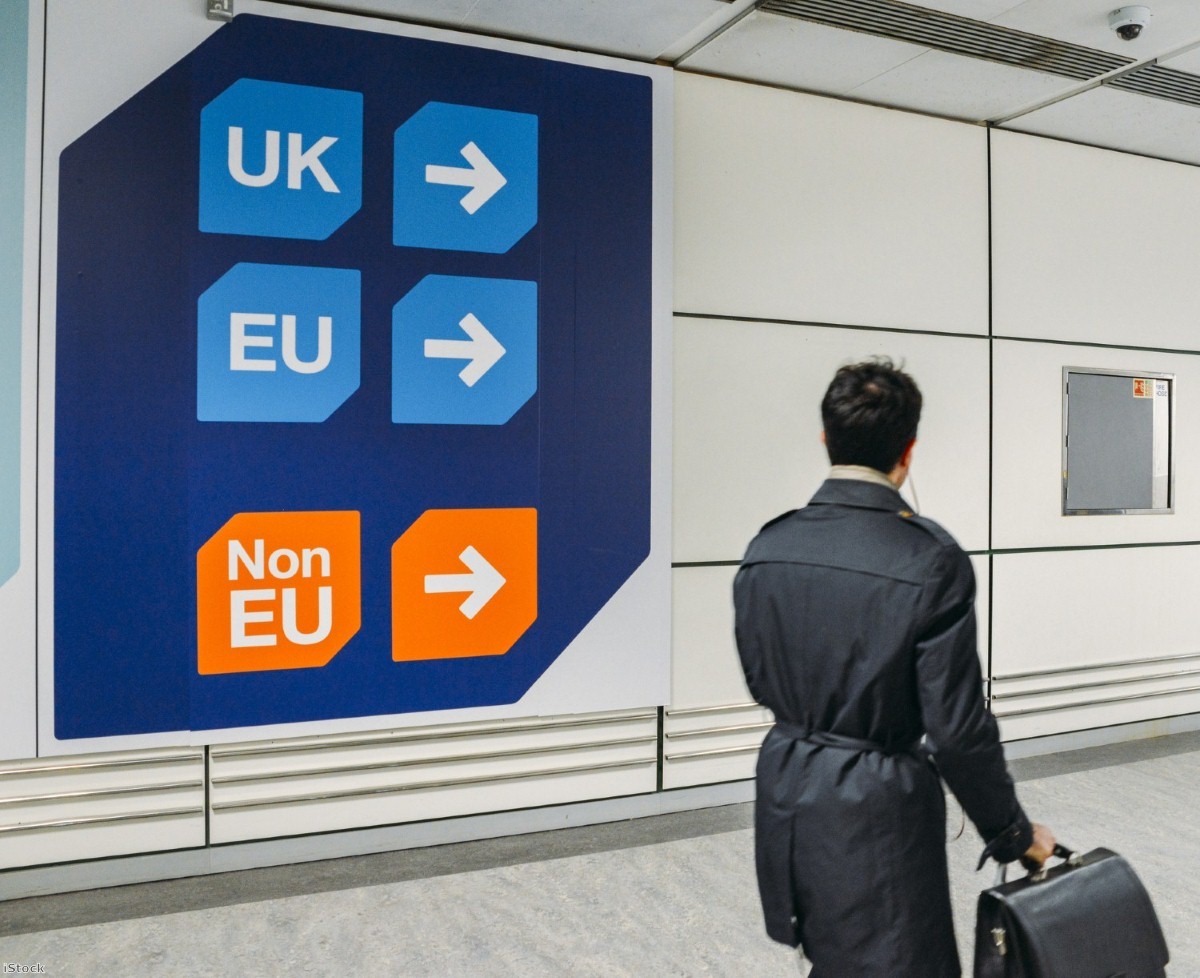 Passenger walks past UK, EU and non-EU sign at the airport | Copyright: iStock