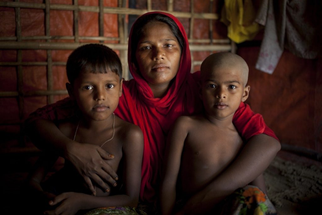 A Rohingya refugee cuddles her children in the camps in Cox's Bazar, Bangladesh. Copyright: Abbie Trayler-Smith/Oxfam