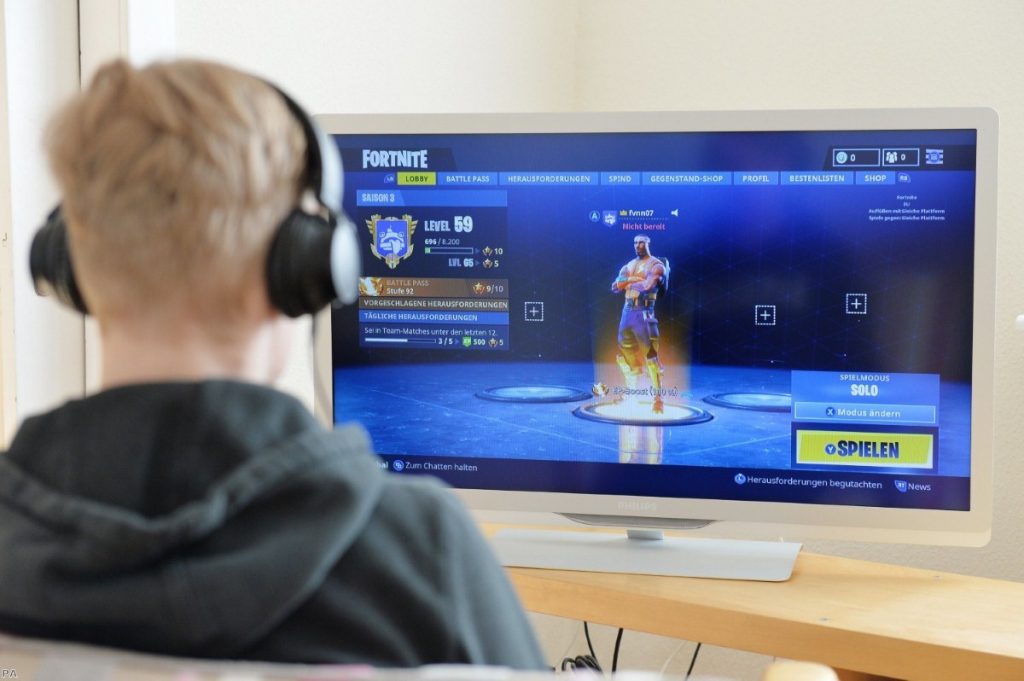 Young man playing the videogame Fortnite | Copyright: PA