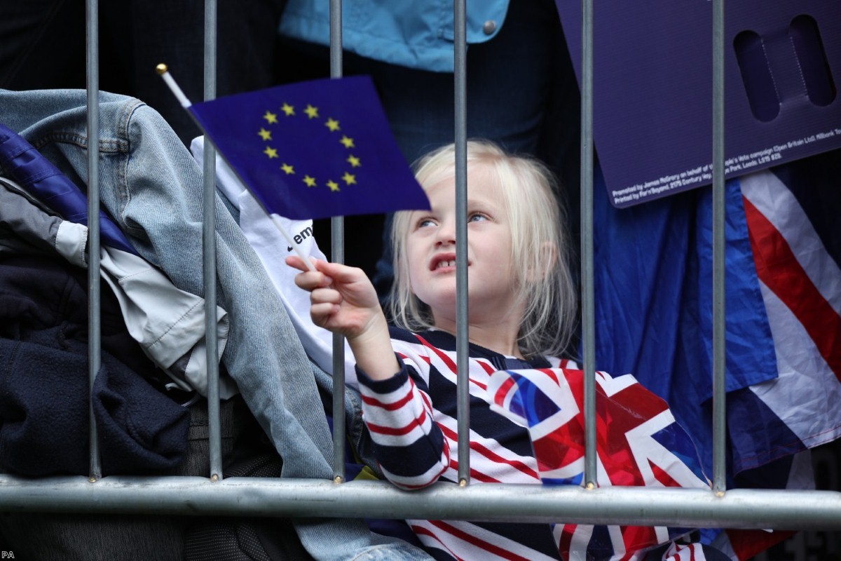 A young protester waves an EU flag at the People's Vote march on Saturday