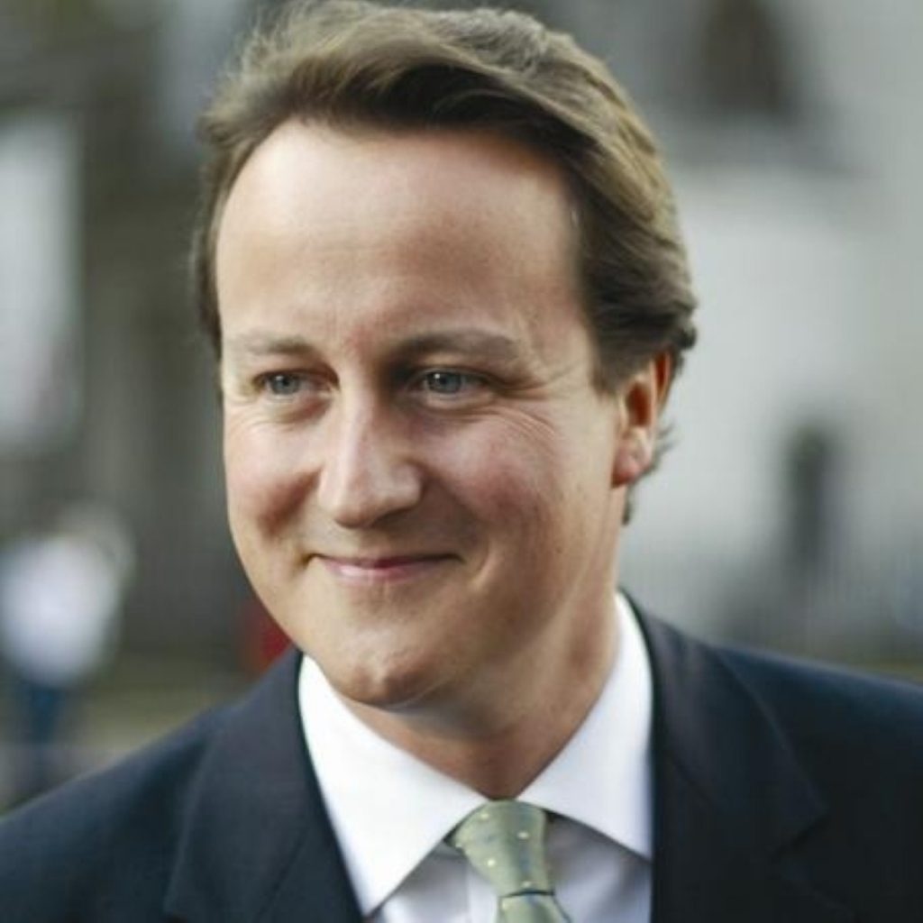 David Cameron has defended his plans to increase international development spending during the recession.
