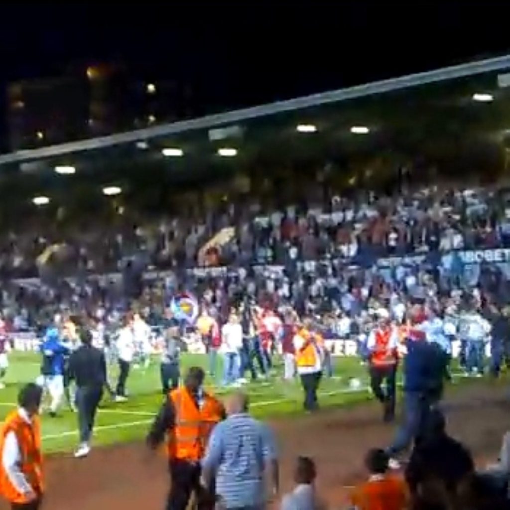 Fans invade the pitch last night