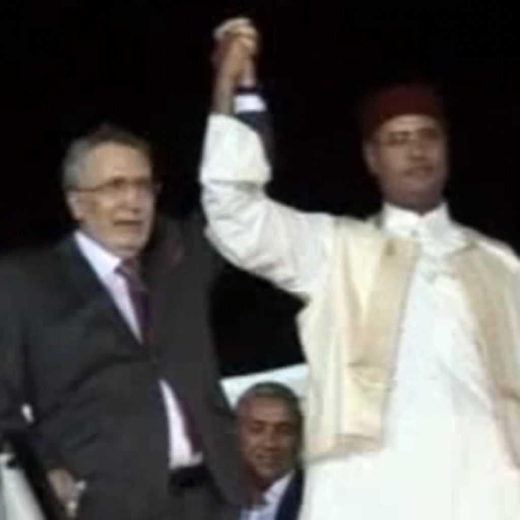 Abdelbaset al-Megrahi (l) was hailed by Libyan leaders on his return