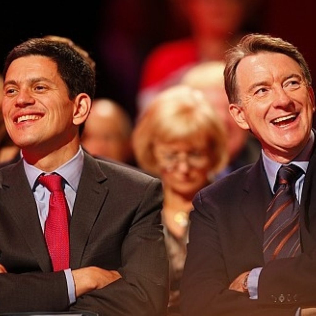 Miliband enjoys a joke with Peter Mandelson earlier in the conference.