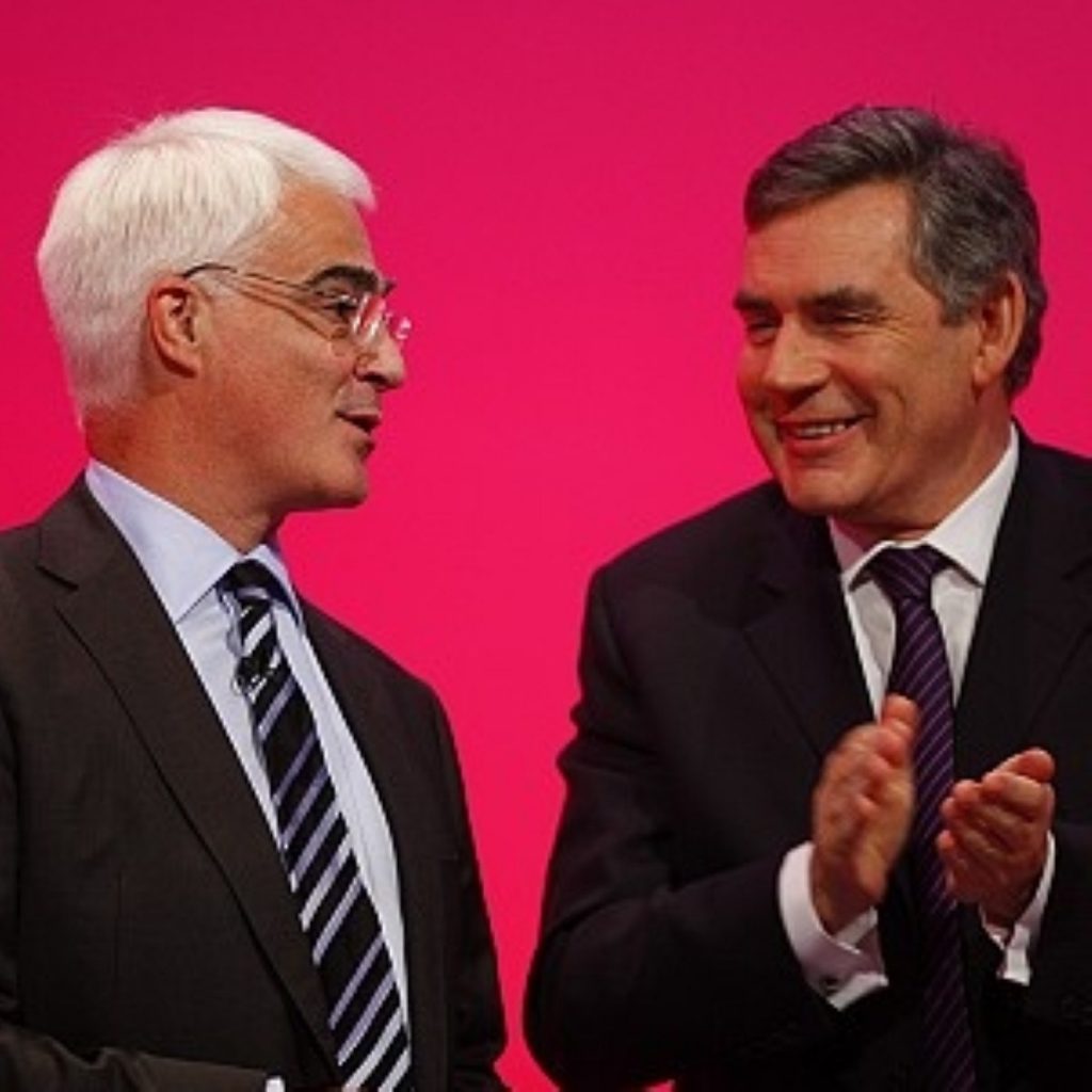 Alistair Darling is congratulated by the prime minister after addressing the conference