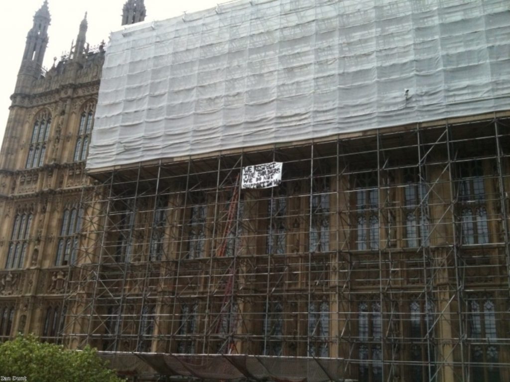 Peace protesters unfurl their banner on top of parliament today