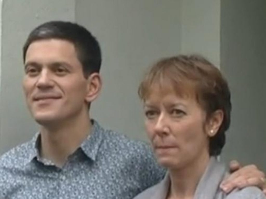 David Miliband appears outside  his home with his wife this afternoon