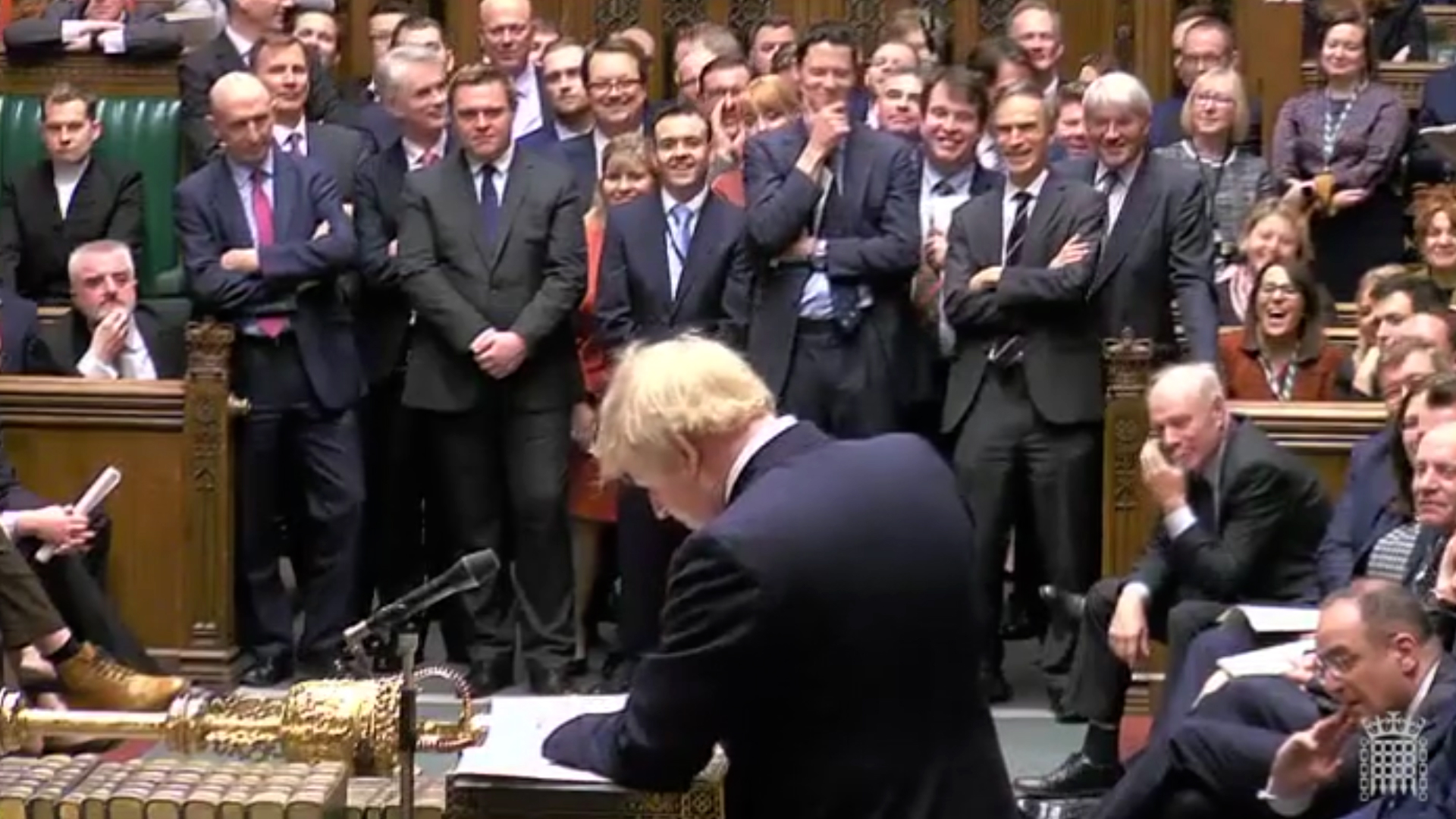 Boris Johnson standing at the despatch box in the House of Commons in front of a group of MPs